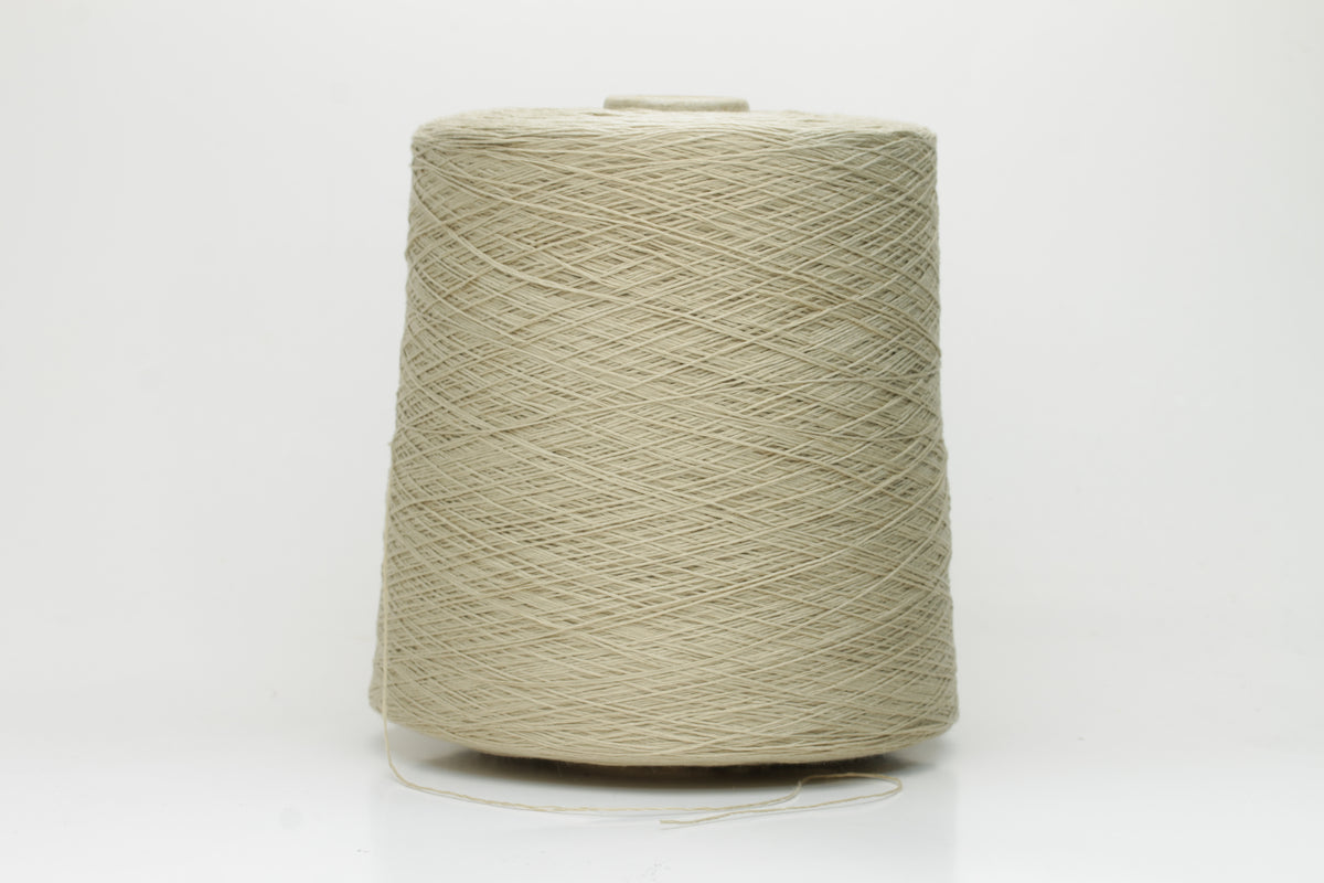 A soft, matte-finish yarn in a delicate light khaki beige, consisting of four finely twisted plies, offering a smooth, even texture.