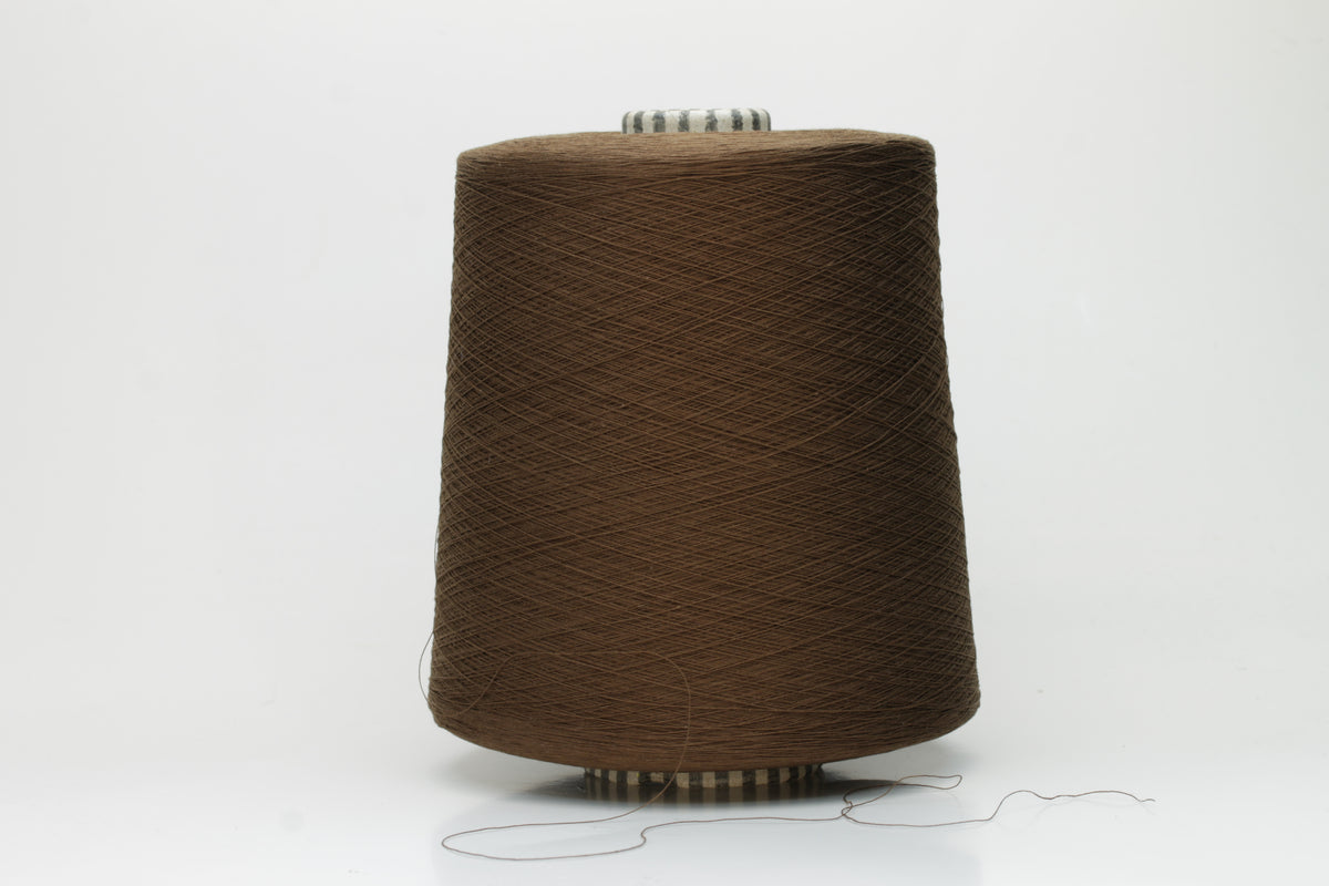Smooth, tightly twisted two-ply cotton yarn in a rich, warm chestnut brown. Displays a subtle sheen and fine, even thread structure.