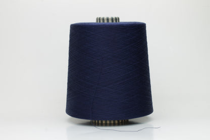 Close-up of a meticulously twisted, fine-gauge cotton yarn in a deep, lustrous classic navy blue with a subtle sheen.
