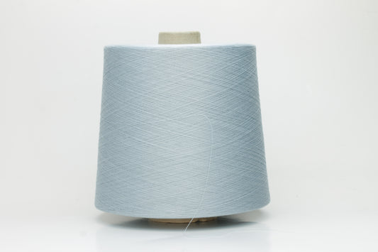 Finely spun Nm 2/140 cotton yarn in a delicate soft sky blue hue, exhibiting a subtle matte sheen and smooth, consistent two-ply twist.