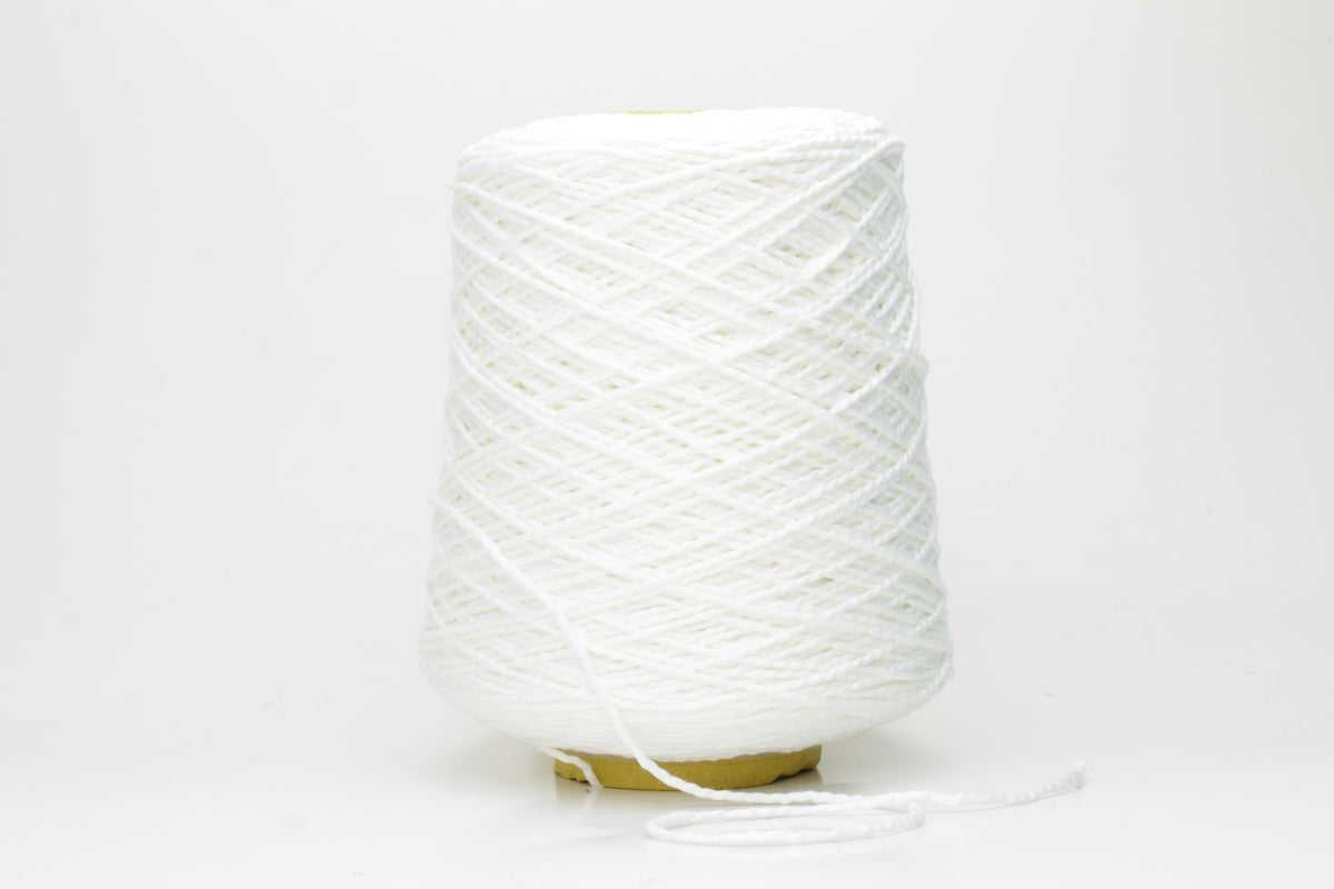Close-up of a pristine white, single-ply cotton yarn with a smooth, even texture and subtle matte sheen, gently coiled.