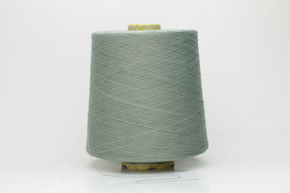 Close-up of a finely twisted Nm 2/50 cotton yarn in a muted, sophisticated sage green heather, exhibiting a subtle matte sheen and uniform ply.