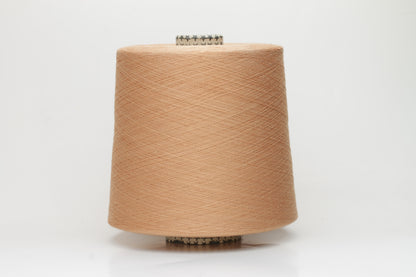 Close-up of finely spun Warm Peach Beige 100% cotton yarn, exhibiting a soft, matte sheen and a gentle two-ply twist. The sophisticated blend of khaki and beige fibers creates a nuanced, earthy tone.