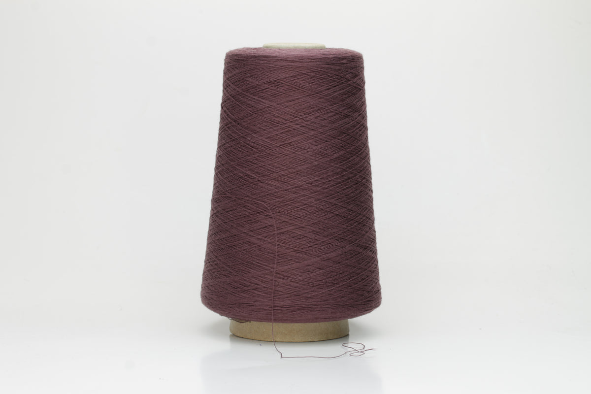 A finely spun, smooth cotton yarn, tightly plied, showcasing a muted, elegant dusty violet taupe color with a subtle matte sheen. No visible fluff.