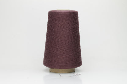 A finely spun, smooth cotton yarn, tightly plied, showcasing a muted, elegant dusty violet taupe color with a subtle matte sheen. No visible fluff.
