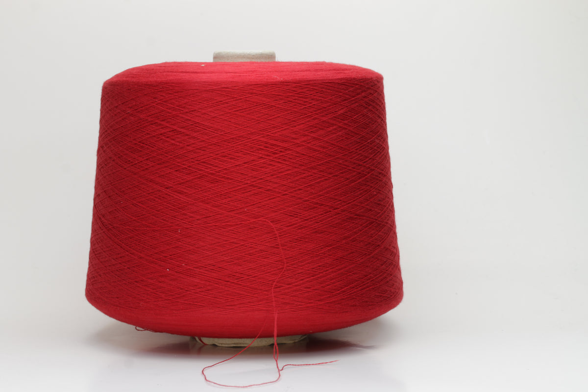 Close-up of a vibrant, rich red cotton yarn. The smooth, tightly twisted 2-ply thread exhibits a subtle sheen and deep, saturated color.