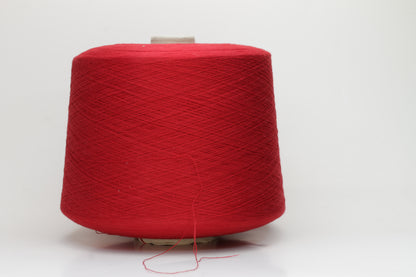 Close-up of a vibrant, rich red cotton yarn. The smooth, tightly twisted 2-ply thread exhibits a subtle sheen and deep, saturated color.