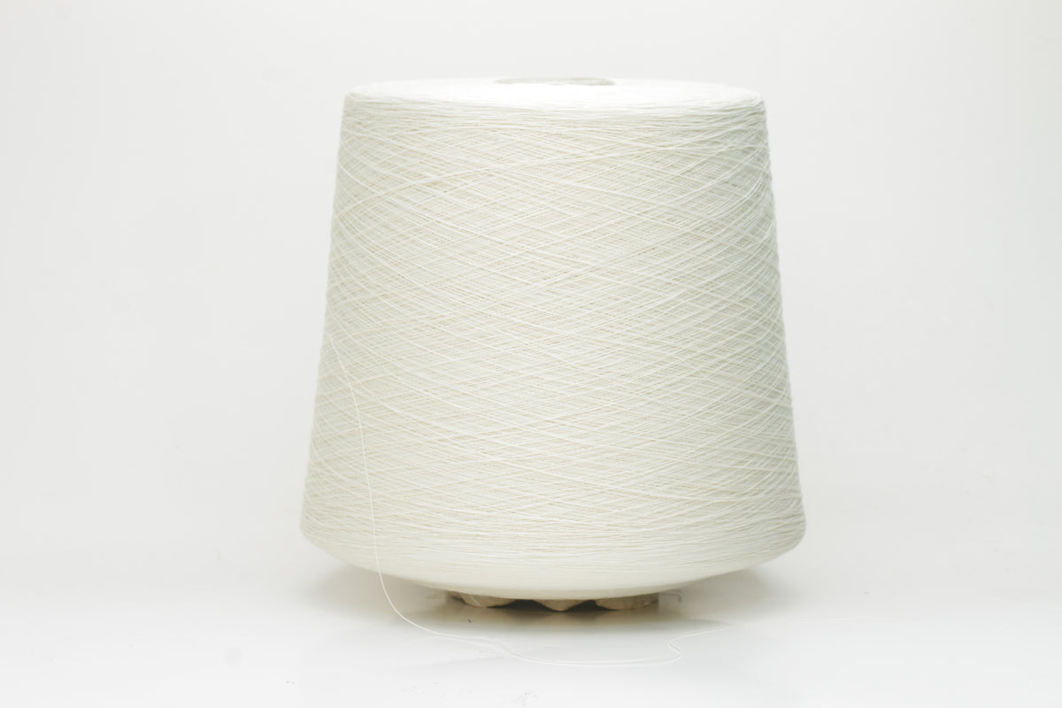 Close-up of pristine white, two-ply cotton yarn, tightly twisted with a subtle matte sheen. Smooth, uniform texture showcasing fine individual fibers.
