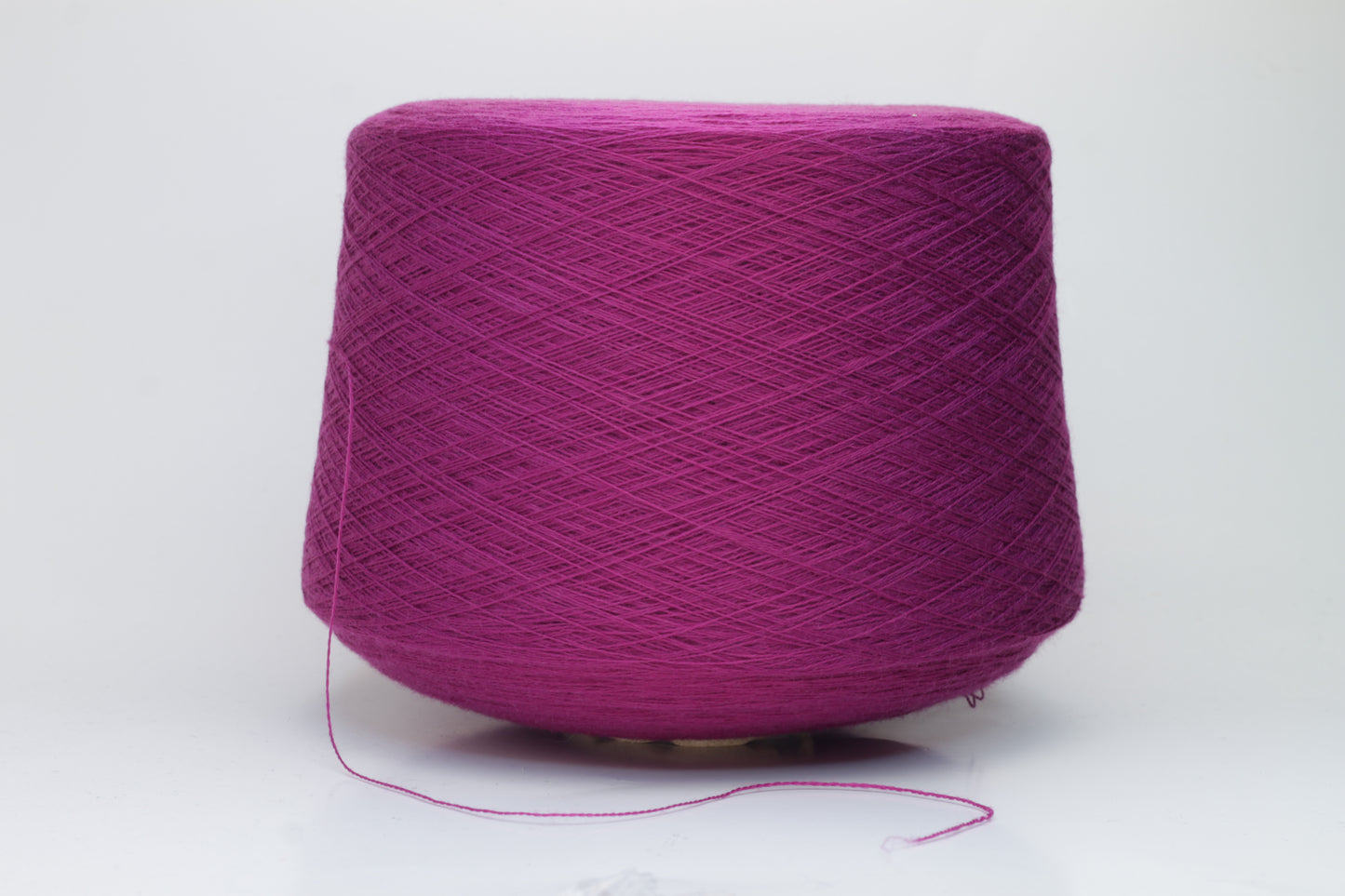 Close-up studio shot showcasing the rich purple color of Zegna Baruffa Merino Cashwool yarn. The yarn features a dense, twisted ply construction with a subtle sheen and inviting fluffiness.