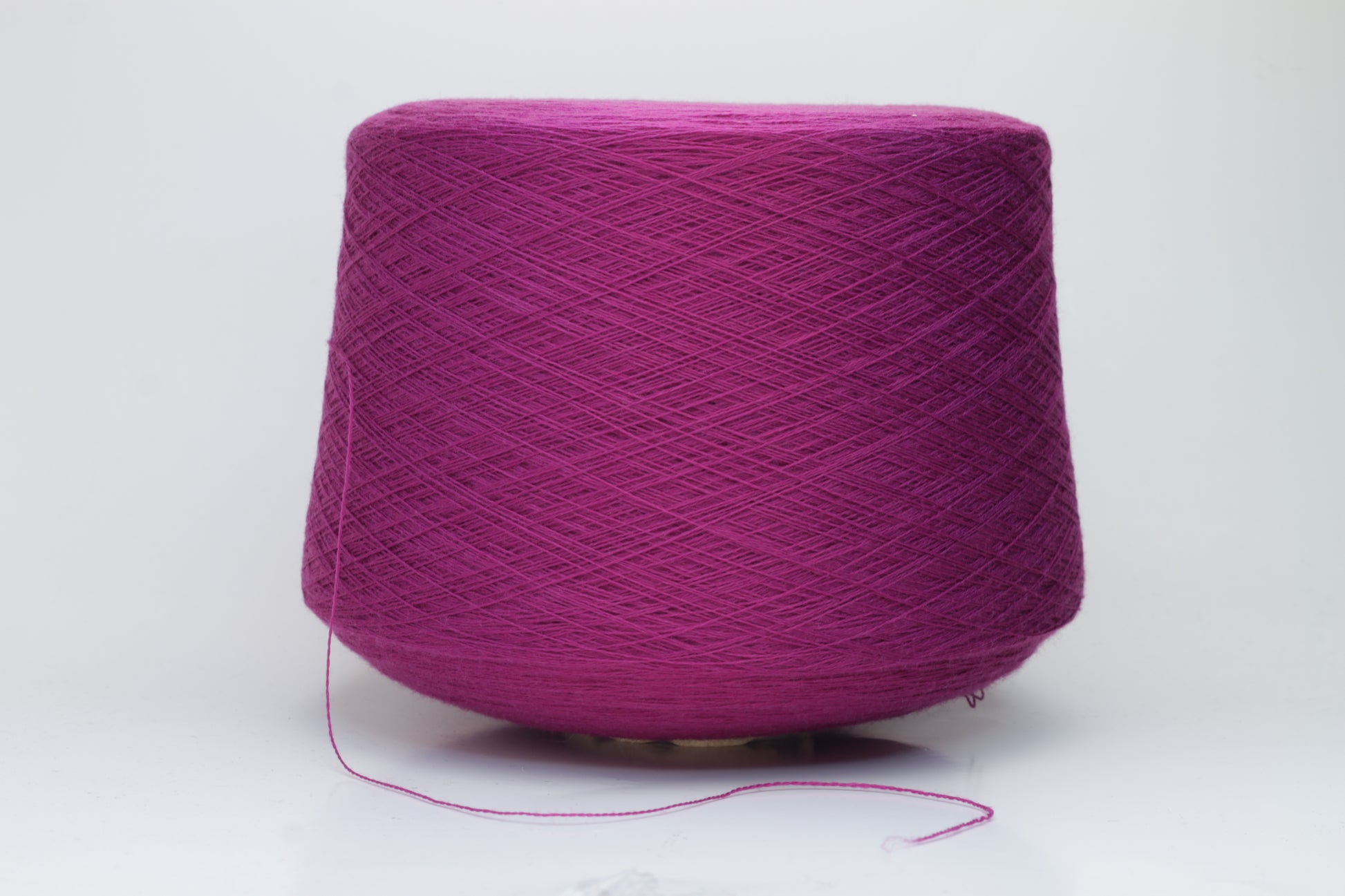 Close-up studio shot showcasing the rich purple color of Zegna Baruffa Merino Cashwool yarn. The yarn features a dense, twisted ply construction with a subtle sheen and inviting fluffiness.