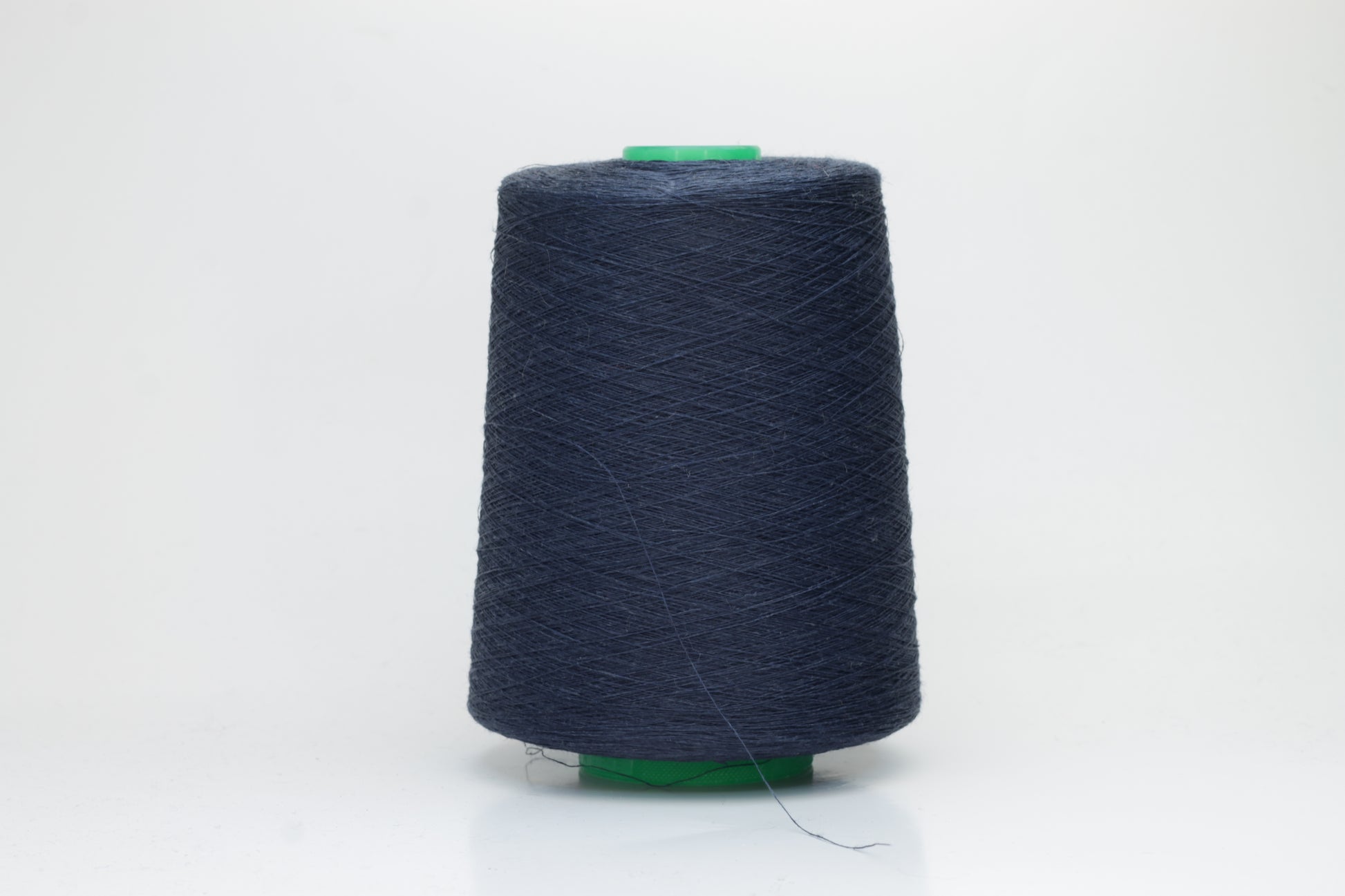 Fine, single-ply linen yarn in a rich Marina. Reveals a crisp texture and subtle natural sheen, typical of pure linen fiber.