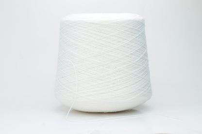 Close-up of a pure white cashmere yarn skein, showcasing its soft, slightly fluffy texture and subtle sheen with a gently twisted, fine two-ply structure.