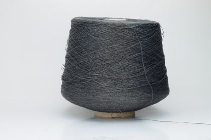 Close-up of a neatly wound skein of fine, smooth brownish-grey linen yarn, exhibiting subtle natural slub variations and a gentle matte sheen.