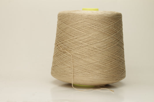 Close-up of a single strand of lustrous, fine-gauge beige silk and cotton yarn, showcasing its smooth, even twist and soft sheen.