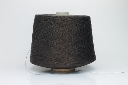 Close-up of a tightly twisted, smooth dark chocolate brown yarn strand, likely two-ply, with a subtle natural sheen.