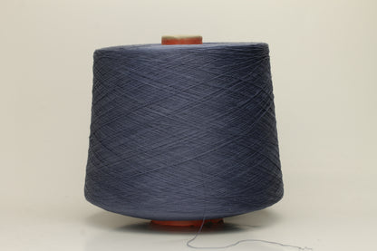 A tightly spun two-ply thread of very fine silk, exhibiting a deep, rich indigo blue hue with a natural, subtle shimmer under light.