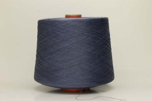 A tightly spun two-ply thread of very fine silk, exhibiting a deep, rich indigo blue hue with a natural, subtle shimmer under light.