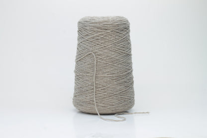 A finely spun, single-ply cashmere yarn in a rich, warm squirrel-brown, exhibiting a delicate halo of soft fibers and a subtle, natural sheen.