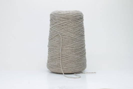 A finely spun, single-ply cashmere yarn in a rich, warm squirrel-brown, exhibiting a delicate halo of soft fibers and a subtle, natural sheen.