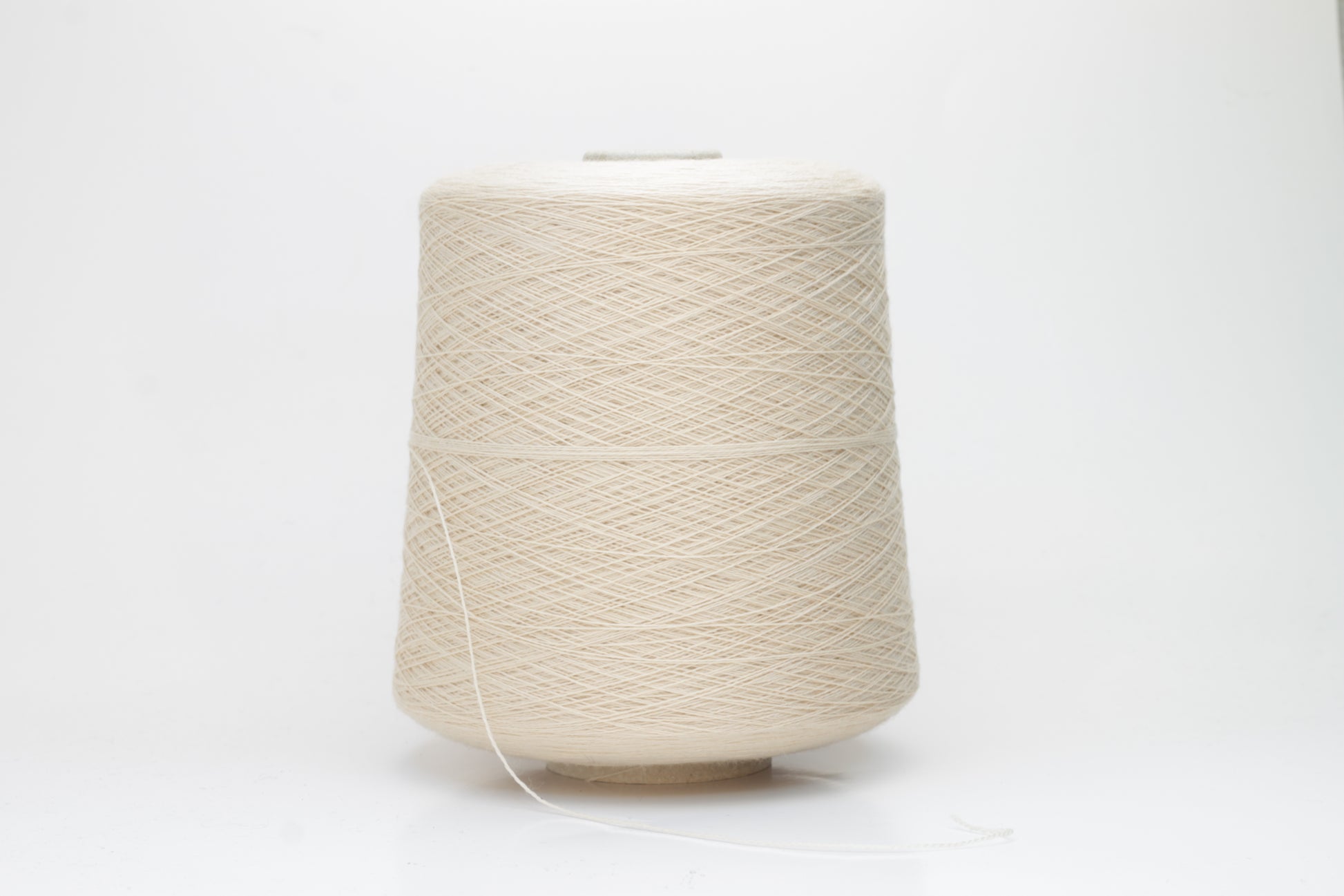 Close-up of luxurious Beige Merino wool yarn, two-ply twist with a soft, subtle sheen, and fine, consistent thread structure.