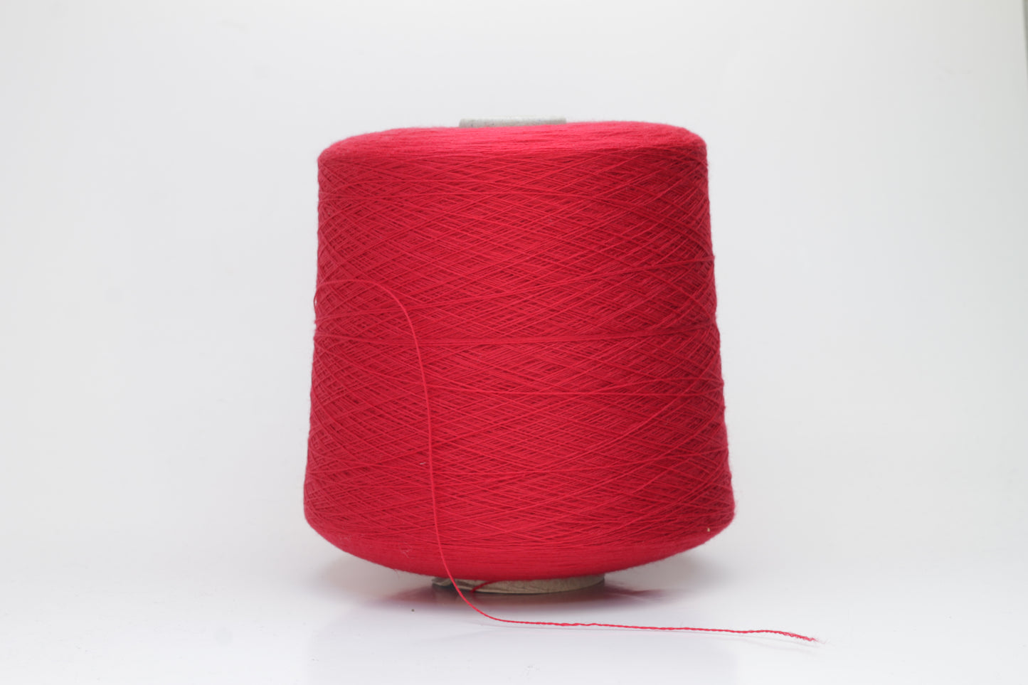 Close-up of luxurious Red Merino wool yarn, two-ply twist with a soft, subtle sheen, and fine, consistent thread structure.