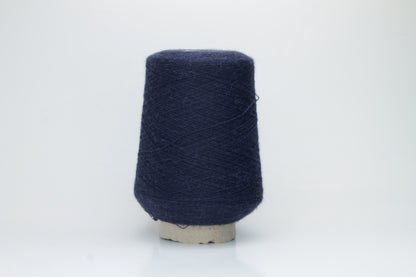 Close-up of Quipa Nm 2/28 Alpaca Merino yarn, showing its soft, slightly diffused fibers and a tight, even two-ply twist in a rich, dark navy hue.