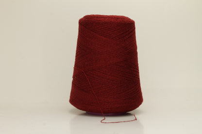Close-up of fine 2-ply pure cashmere yarn in a rich, velvety burgundy red with subtle rosy undertones, showing its soft sheen and delicate fluff.