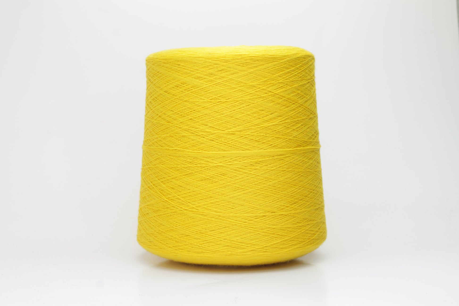 Close-up of luxurious Yellow Merino wool yarn, two-ply twist with a soft, subtle sheen, and fine, consistent thread structure.