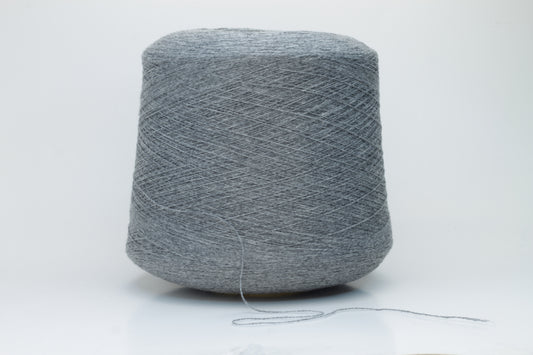 Skein of fine, two-ply cashmere yarn in a sophisticated medium gray, exhibiting a soft, subtle halo and delicate matte sheen.