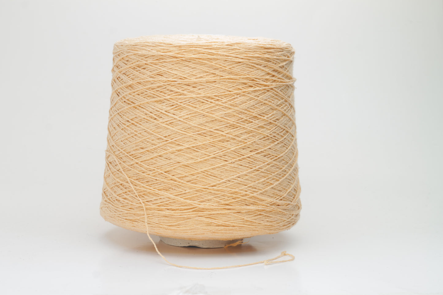 Close-up shot of a vibrant Muskemelon colored silk bourette yarn, showcasing its fluffy texture and intricate ply twist, with subtle sheen and depth.