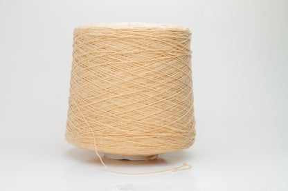 Close-up shot of a vibrant Muskemelon colored silk bourette yarn, showcasing its fluffy texture and intricate ply twist, with subtle sheen and depth.