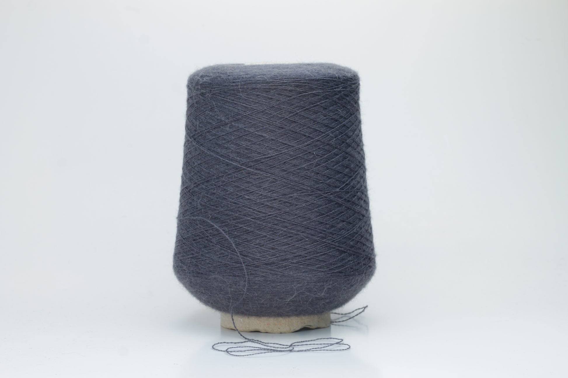 Rich Gray 2-ply Alpaca Merino yarn, softly twisted with a gentle halo and subtle sheen, showcasing its deep, luxurious color saturation.