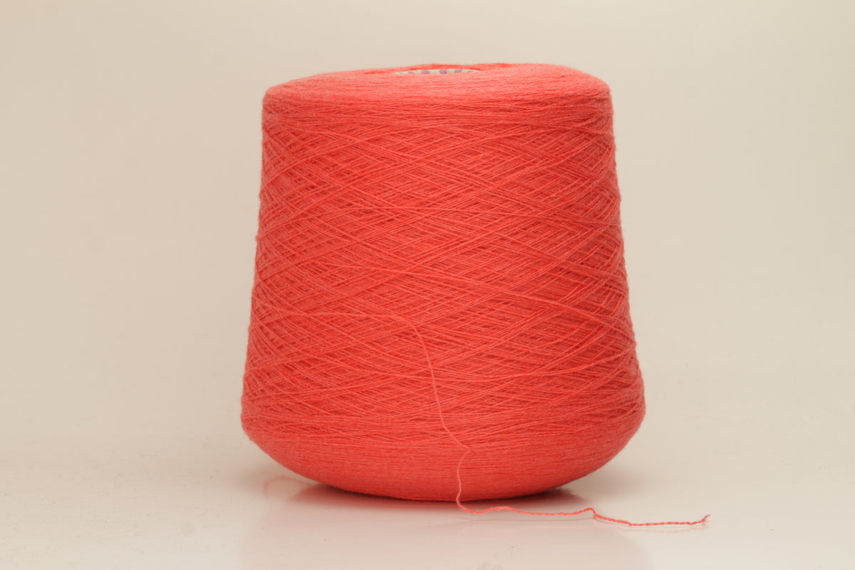 Luxurious two-ply cashmere yarn in vibrant coral (Corallo), showcasing a soft, subtle twist, smooth texture, and elegant natural sheen.