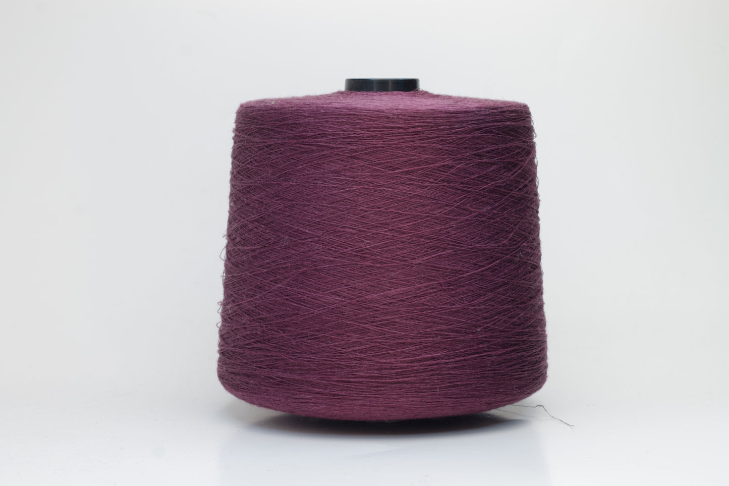 Fine, single-ply linen yarn in a Cardinal. Reveals a crisp texture and subtle natural sheen, typical of pure linen fiber.