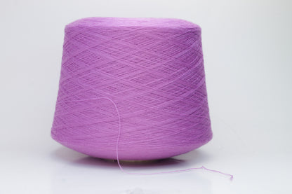 Close-up image showcasing a vibrant purple 100% merino yarn skein with a slight twist, revealing the fine ply structure and rich color depth; the fiber appears fluffy and soft.