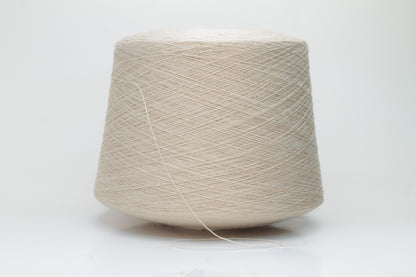 Close-up shot of creamy beige merino yarn, featuring a tight ply twist and a subtle sheen. The fibers exhibit exceptional fluffiness and texture, ideal for intricate knitting patterns.