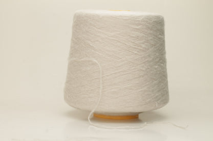 Luxurious, pristine white single-ply silk yarn with a smooth, uniform texture and a delicate sheen, softly coiled.