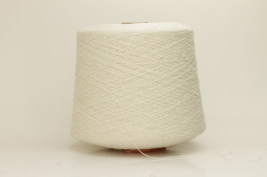 Close-up of a pure white, textured Nodino yarn, showing subtle, irregular nubs and a soft, matte sheen; twisted ply visible.