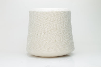 Close-up of a finely spun, 2-ply cashmere yarn skein in a delicate, warm champagne beige. Features a soft, subtle napped texture and elegant sheen.