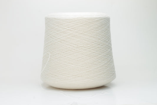 Close-up of a finely spun, 2-ply cashmere yarn skein in a delicate, warm champagne beige. Features a soft, subtle napped texture and elegant sheen.
