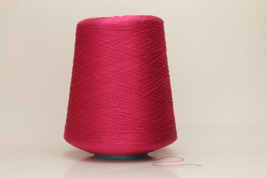 Close-up of vibrant hot pink 100% pure silk yarn, showcasing its fine, smooth single ply and high, natural luster reflecting light beautifully.