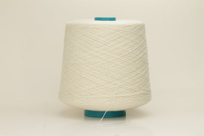Close-up of a two-ply fine cashmere yarn, tightly twisted with a subtle matte sheen in a creamy off-white Gesso color.
