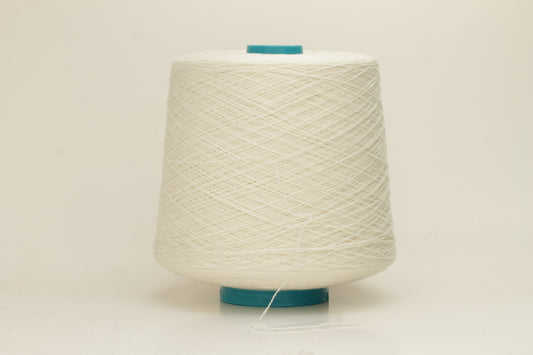 Close-up of a two-ply fine cashmere yarn, tightly twisted with a subtle matte sheen in a creamy off-white Gesso color.