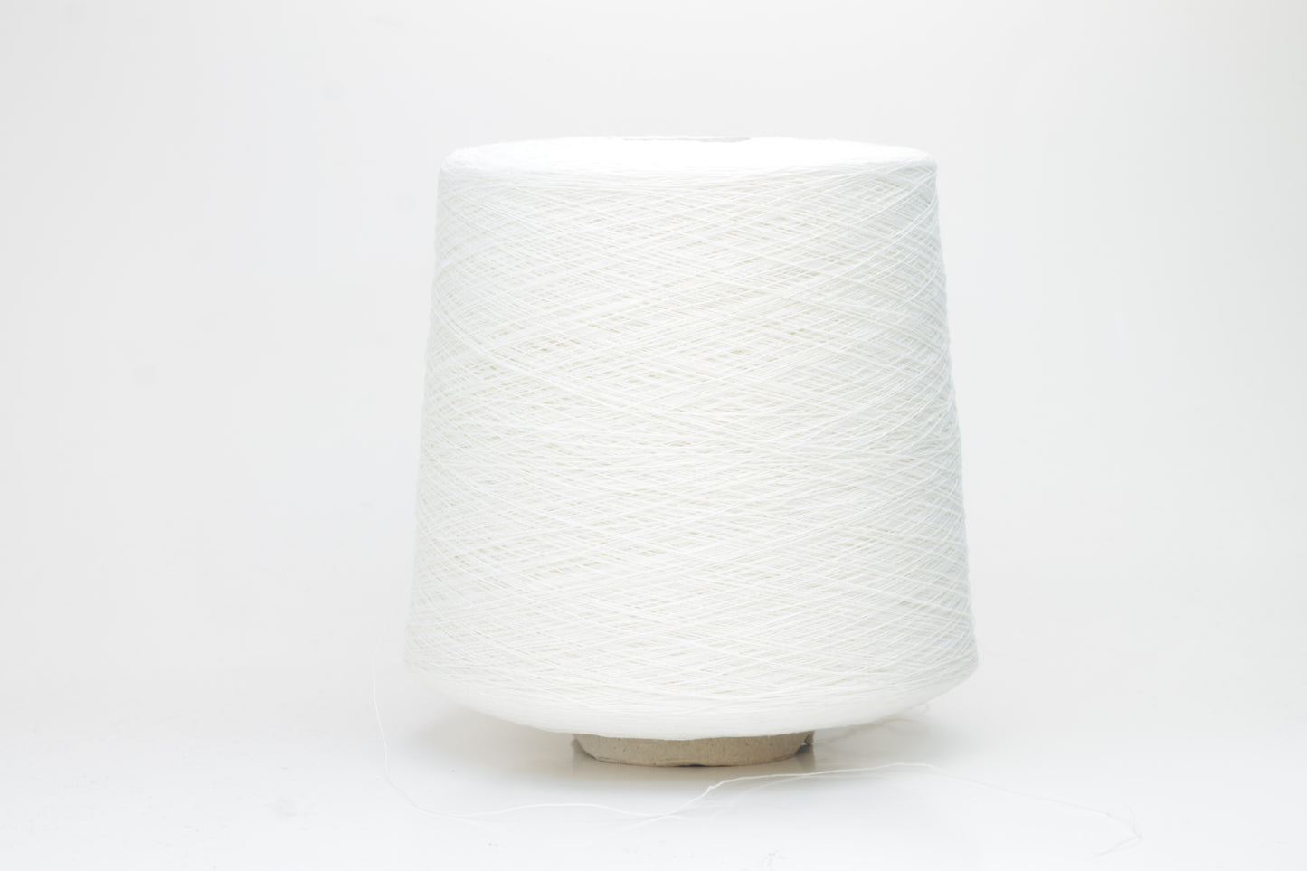 A soft white three-ply linen yarn, tightly twisted with a subtle natural sheen, presented in a neatly wound skein, showcasing its crisp, cool texture.