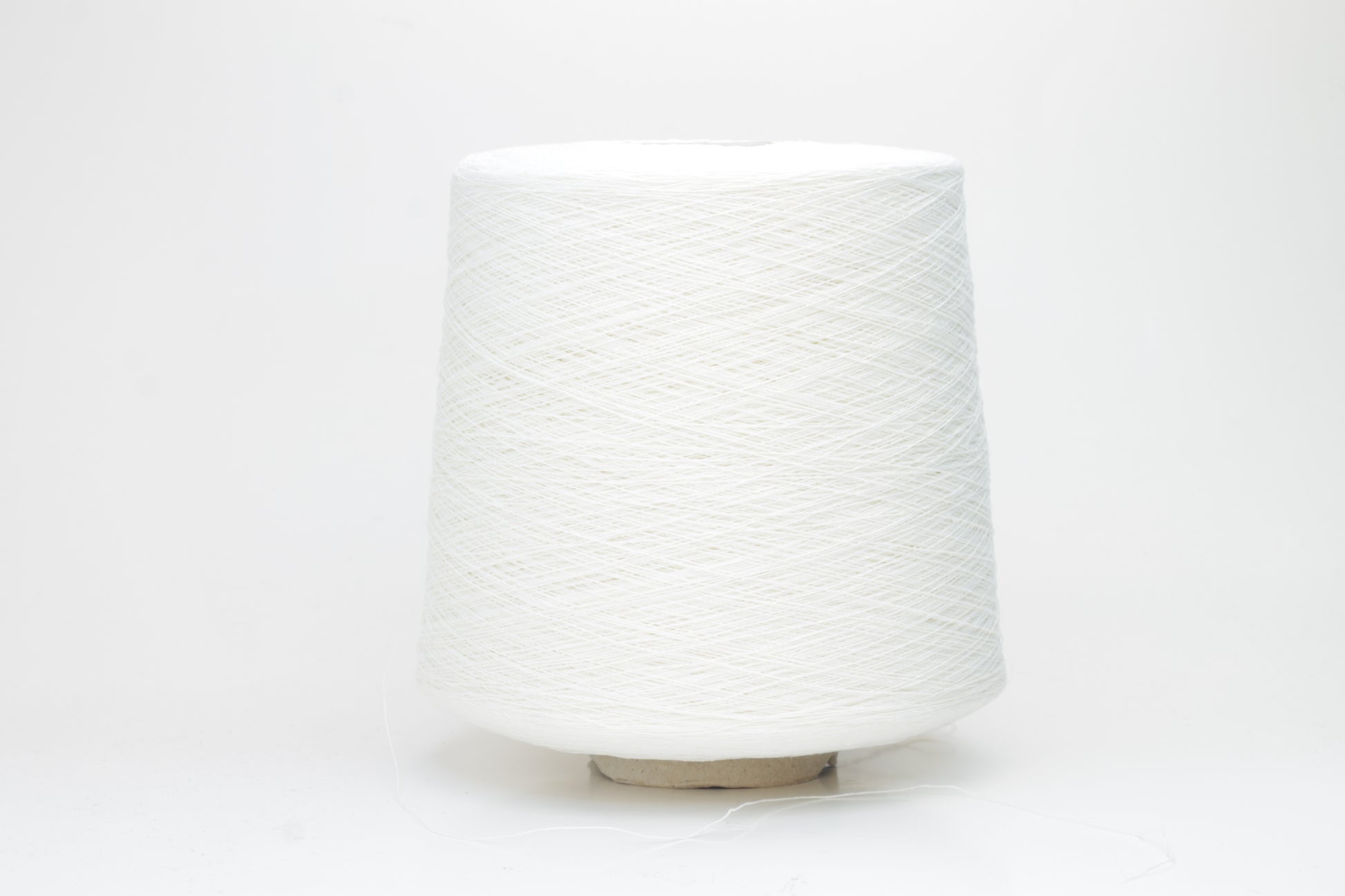 A soft white three-ply linen yarn, tightly twisted with a subtle natural sheen, presented in a neatly wound skein, showcasing its crisp, cool texture.