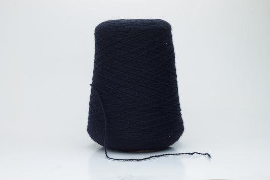 Luxurious, evenly spun two-ply yarn in a deep, rich matte navy blue. The cashmere fibers exhibit a soft halo and subtle natural sheen.