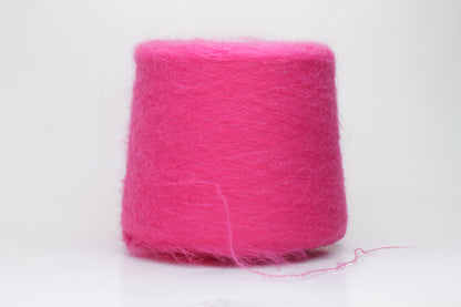 Close-up view of SuperKidMohair yarn in Fuxia, showcasing its fluffy texture and slightly twisted ply structure with subtle sheen.