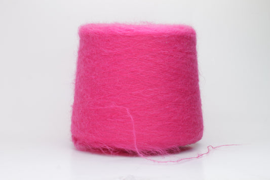Close-up view of SuperKidMohair yarn in Fuxia, showcasing its fluffy texture and slightly twisted ply structure with subtle sheen.