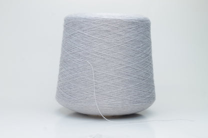 Close-up of a luxurious light blue merino wool yarn skein, showcasing its fine ply twist and subtle sheen, emphasizing the soft fluffiness and vibrant color depth.