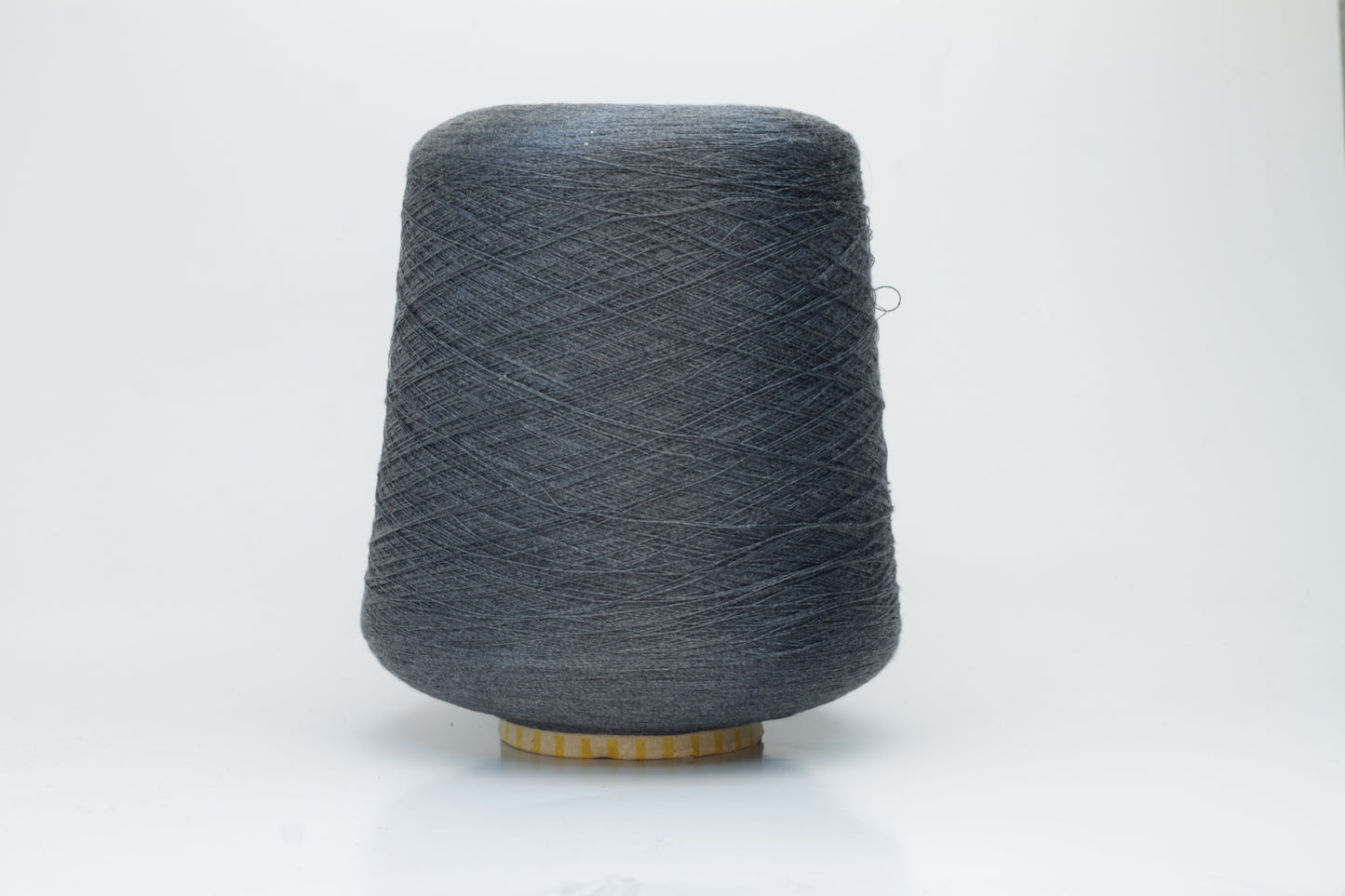 Close-up of a finely spun, lustrous dark gray silk yarn, exhibiting a smooth surface and a subtle sheen. The tightly twisted plies are visible, creating a refined, consistent thread structure.